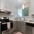 Kitchen with stainless steel appliances and grey and white cabinets