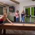 Residents playing shuffleboard inside the upgraded community clubhouse.