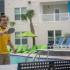 Young man playing table tennis along side the community pool.