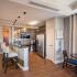 Community clubhouse kitchen with pendant lighting, island, and stainless-steel appliances at Prospect Hall Apartments