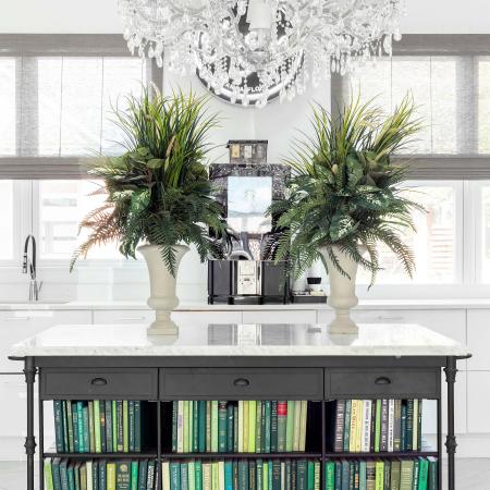 1810 The Social, interior, white wall, windows, white floor, chandelier, potted plants, coffee maker, table with books on bottom shelves, green tones