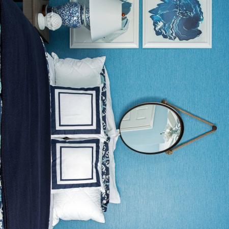 1810 The Social, interior, bedroom, blue and white decor, bed, mirror, night stand, lamp, wall decor