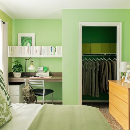 1810 The Social, interior, bedroom, green and white decor, bed, bed curtain, desk, chair, shelves, dresser, closet