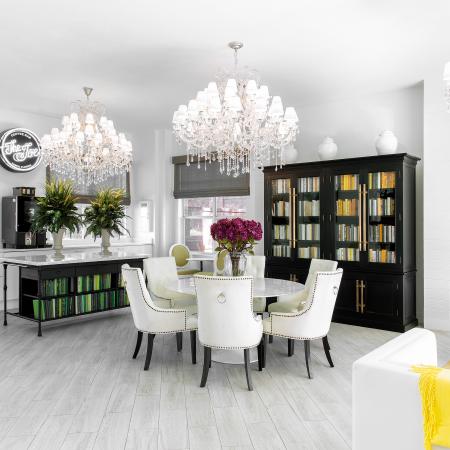 1810 The Social, interior, library, white table ad chairs, white walls, white floor, accents of yellow, green and black