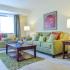 Brookstone Apts; Interior, living room, sofa, 2 side tables, loveseat, balcony with custom blinds