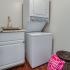 Canyon Square Apartments & Townhomes, interior, laundry room, wood floor, laundry basket, pink towel, stacked washer and dryer, sink, cabinet