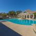 Creekside Park Apartments, exterior, sparkling blue swimming pool, lounge chairs, trees, clubhouse