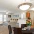 Creekside Park Apartments, interior, living room, dining room, kitchen, carpet and tile, couch, chairs, dark dining set, wood cabinets, white appliances, refrigerator, dishwasher, large windows