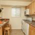 galley kitchen with cut out and updated white appliances, gas range, frost free fridge, dishwasher
