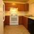 Galley Kitchen with electric range dishwasher and refrigerator