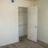 A bedroom area with closet and grey carpet. | On-Base Housing Holloman AFB, NM