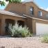 A light brown, two-story home with a rock yard. | Military-Friendly Rental Houses Alamogordo, NM