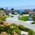 A cul-de-sac with several two-story houses and varying colors. The cul-de-sac overlooks the ocean. | Homes for rent near Los Angeles AFB
