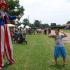 Woman on stilts and families at a community event | Fort Knox Military Housing
