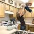 Woman playing with child in kitchen