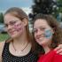 2 women with painted faces at community event