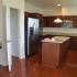 A kitchen with dark flooring and cabinets. | Rental Houses on Peterson AFB, Colorado Springs, CO