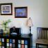 A dark shelf with colorful paneling sits against the wall in a dining room. | North Haven Family housing