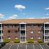 Landscaped building grounds and parking at Westford Park apartments in Lowell, MA.