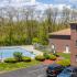 Pool area and mature landscaping at Westford Park apartments in Lowell, MA.