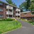 Exterior photo showing walkway and bench in front of building Apartments Nashua NH | Pheasant Run Apartments