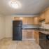 Kitchen with black appliances  in apartment at Pheasant Run  | Nashua NH Apartments