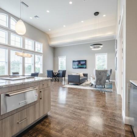 Open concept living area with wood plank style floor and stainless steel appliances | Apartments For Rent In Chelmsford MA | Mill and 3 Apartments