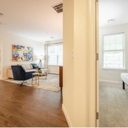Spacious living room between two bedrooms at Mill & 3 Apartments  in Chelmford, MA.