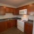 Newly remodeled kitchen with white appliances and cherry oak cabinets