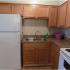 Newly remodeled kitchen with white appliances and light brown cabinets