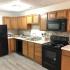 Newly remodeled kitchen with black appliances and tile backsplash