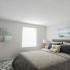 River View Apartments, interior, bedroom, gray tones, carpet, area rug, large bed, window, wall art