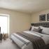 River View Apartments, interior, bedroom, large bed, carpeted, large windows, arm chair,