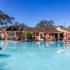 The Avenue Apartments, exterior, sparkling blue pool, clubhouse red brick, trees