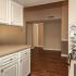The Avenue Apartments, interior, kitchen, dining room, wood floor, white cabinets, black stove/oven, hallways, closet, breakfast bar counter