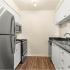 Beneva Place Apartments, interior, kitchen, wood floor, white cabinets, stainless steel appliances, refrigerator, stove/oven, microwave, dishwasher,