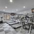 Fitness Center with tredmills facing mirrors and checkerboard flooring