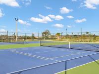 The tennis courts and sports facility near our Apopka townhomes, featuring basketball hoops and surrounding marshes.