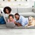 young family at home with laptop and labrador retriever