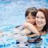 Mother and daughter spending time in swimming pool.