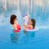 Mother and daughter spending time in swimming pool.
