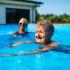 portrait of two women swimming at community pool