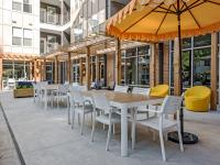 Exterior with canopy covered tales and seating at Latitude at Kent | Apartments near Kent State University