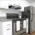 Contemporary kitchen with stainless steel oven and stainless steel refrigerator