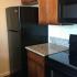 Kitchen with black appliances with granite counters