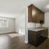 brown cabinets, kitchen with sink and dishwasher, vinyl flooring, window
