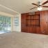 Photo of carpeted living room, screened porch, and oak-styled wall