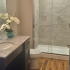 Crescendo Apartments, interior, bathroom, glass shower stall, wood flooring, toilet, single sink vanity and mirror