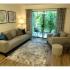 View of upgraded, furnished, model living room with patio sliding glass door