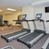Lansdowne Towers fitness center with treadmills and flatscreen television